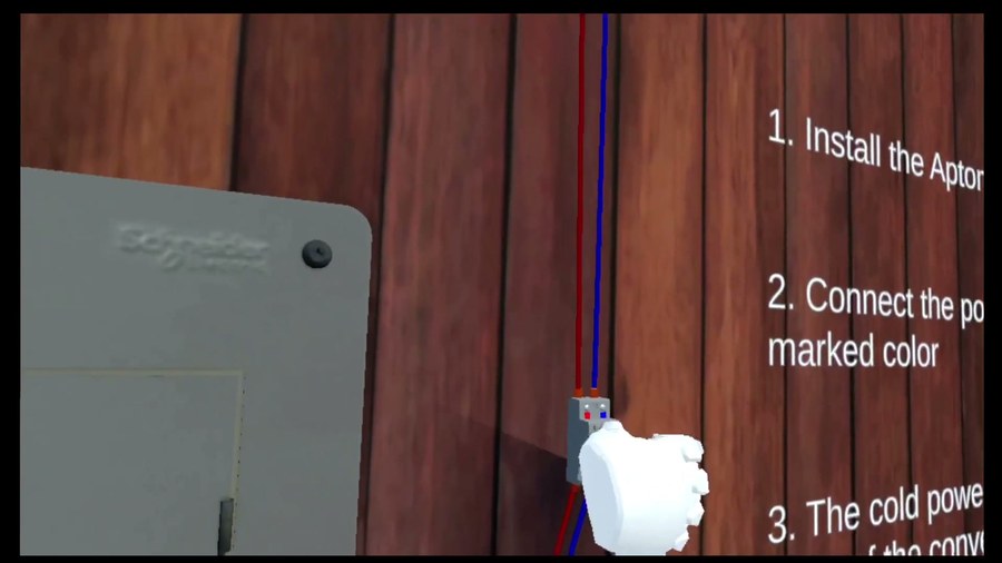 感電防止用遮断器VRの英語版。手で配線を操作しながら英語の手順を確認している画面